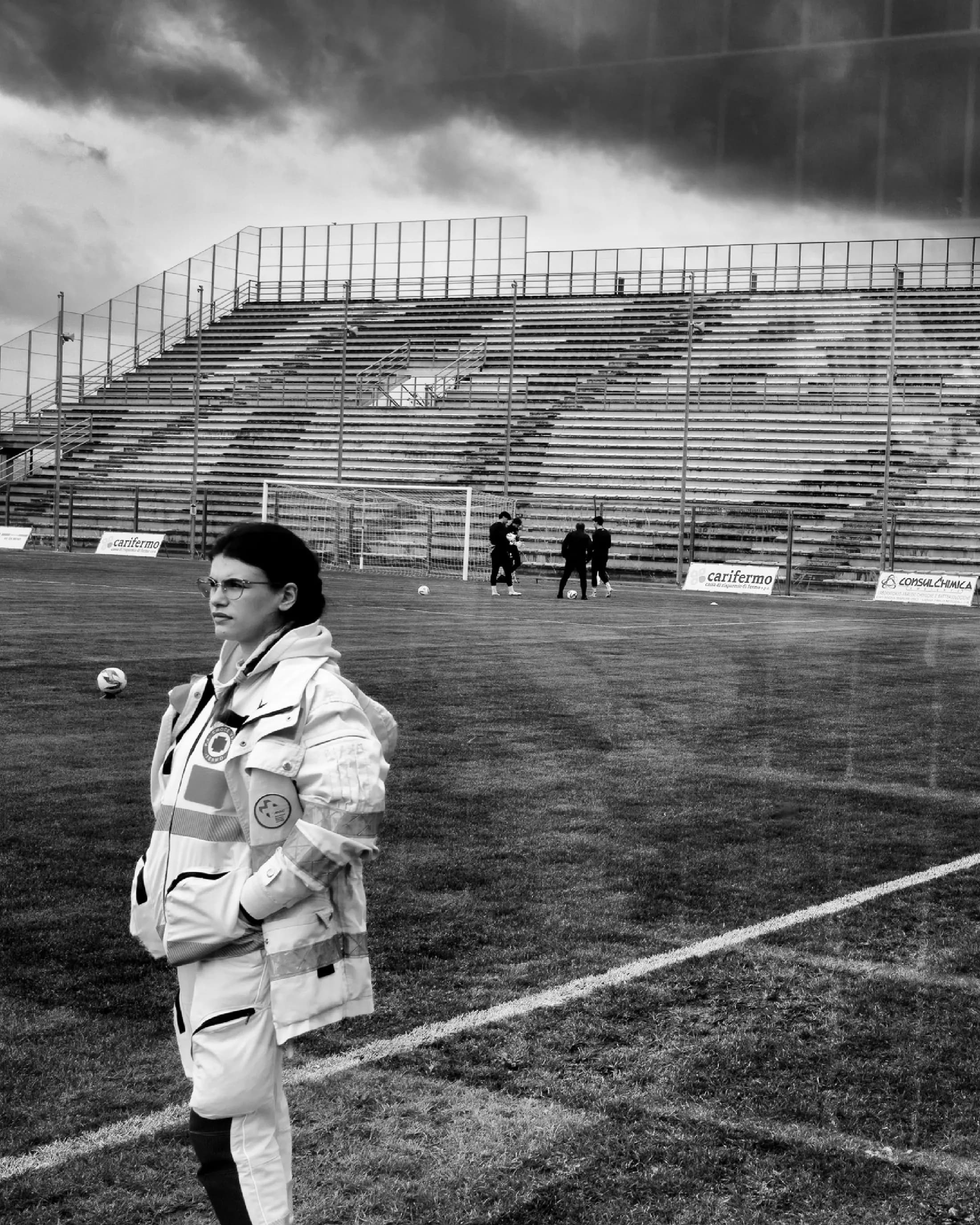 Volontaria di servizio a bordo campo in uno stadio vuoto